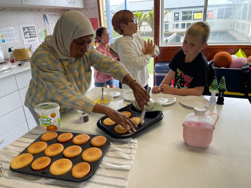 Staff and children baking cupcakes in the centre kitchen